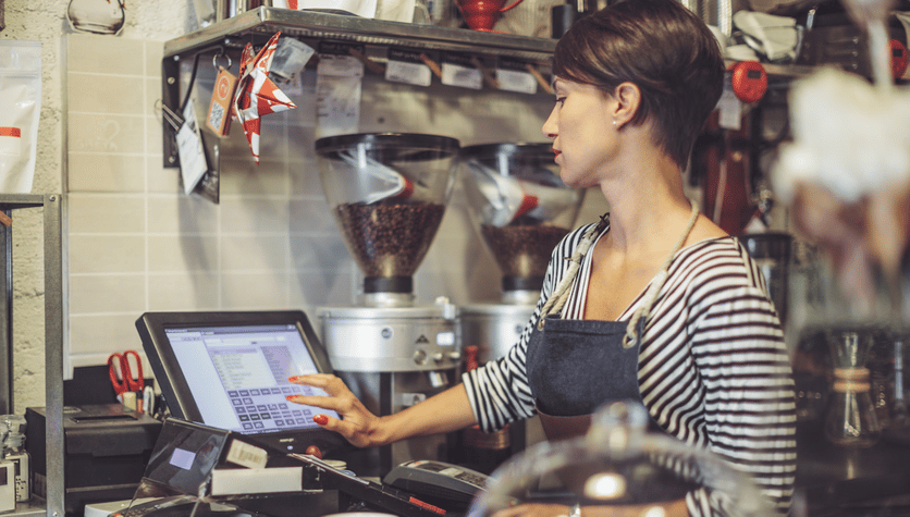 small business owner using a cash register screen